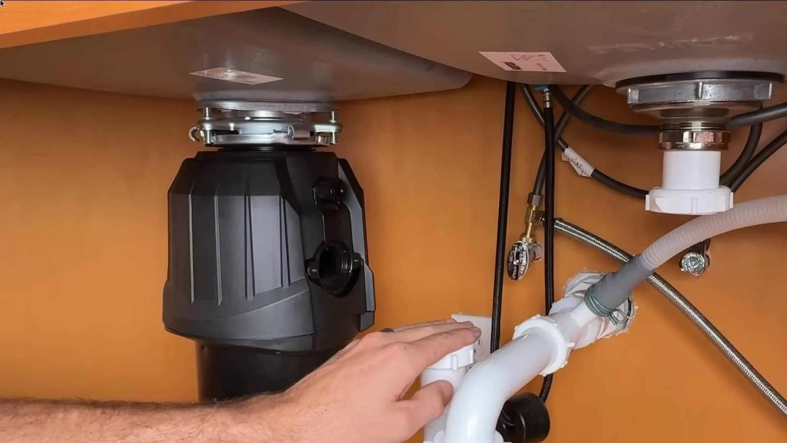Garbage disposal unit mounted under a kitchen sink