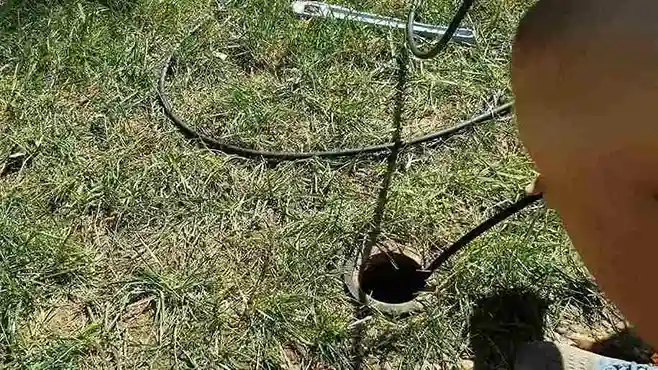 Hydro jetter hose at a sewer cleanout