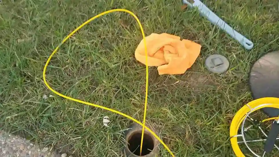 Sewer camera cable going into a lawn cleanout