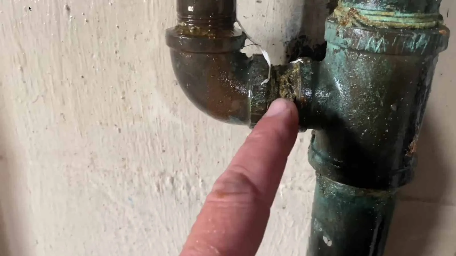 Corroded brass tee found during a leak detection visit