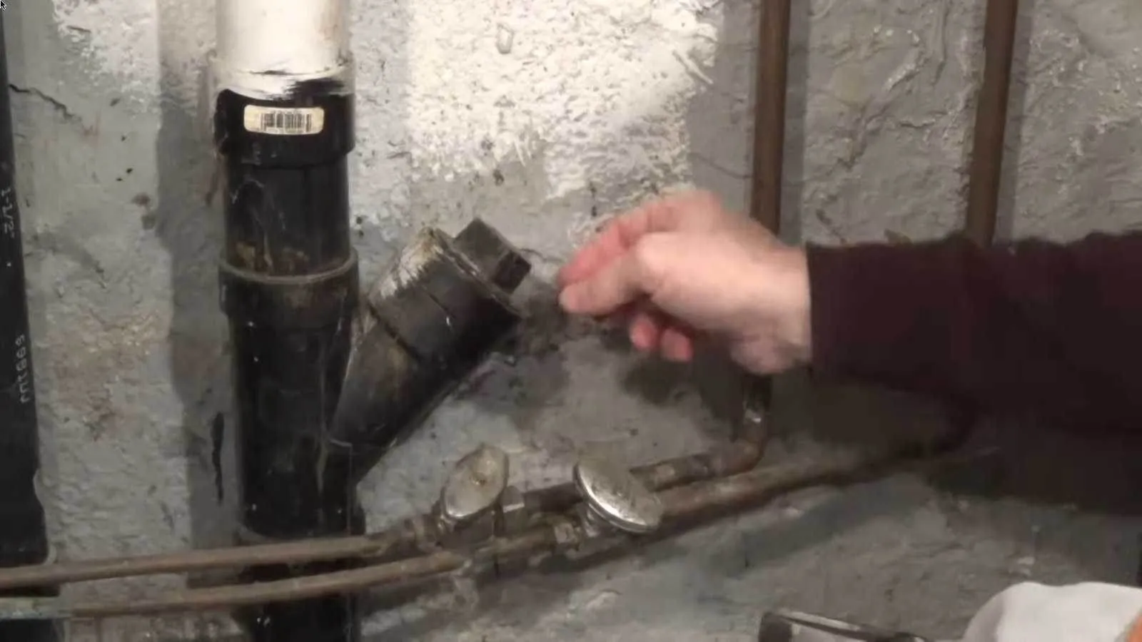 Drain cleaning cable machine clearing a clogged drain
