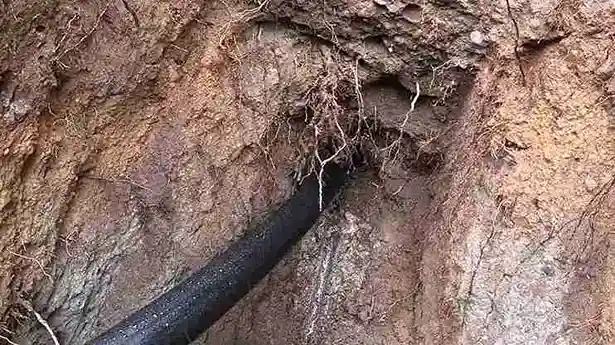 New HDPE pipe being pulled through a trenchless bore