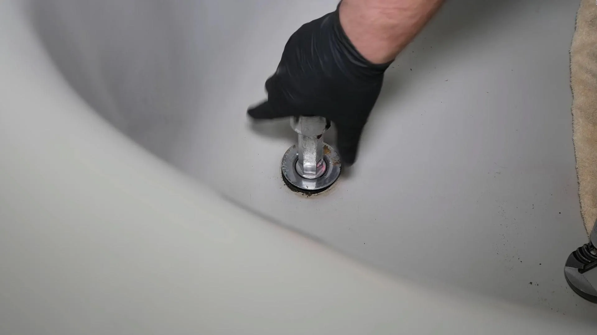Wrench on a bathtub drain fitting during installation