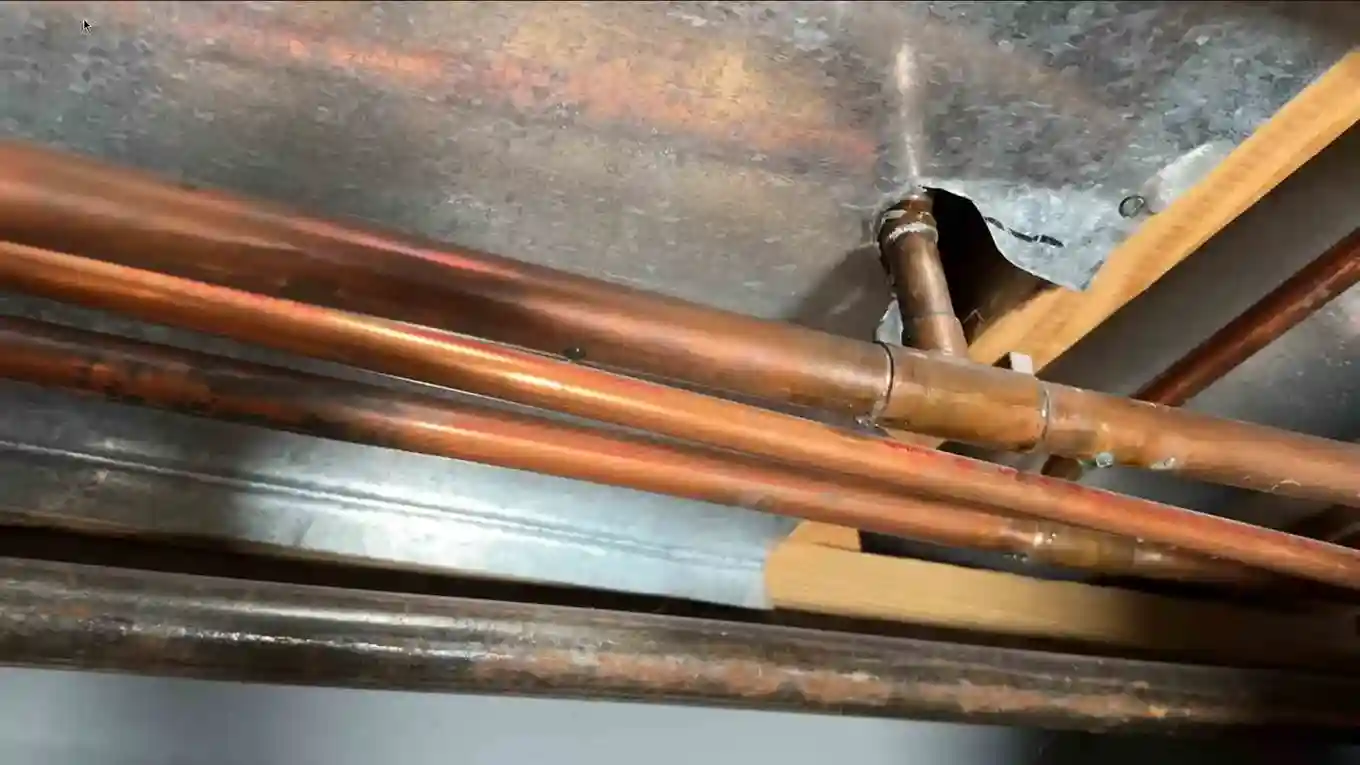 Pinhole corrosion spots on copper lines in a basement ceiling