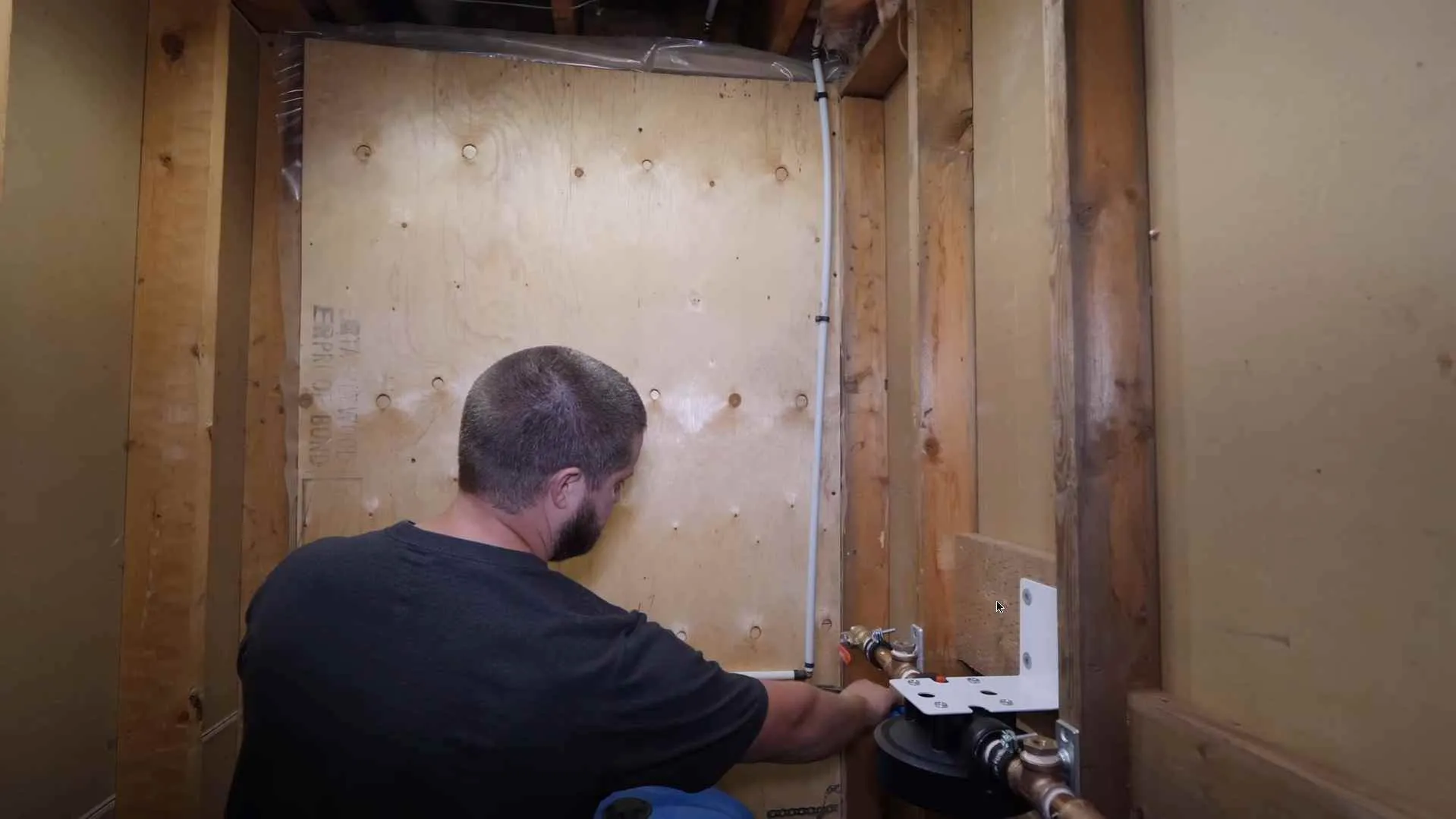 Whole house water filter head installed in a basement alcove