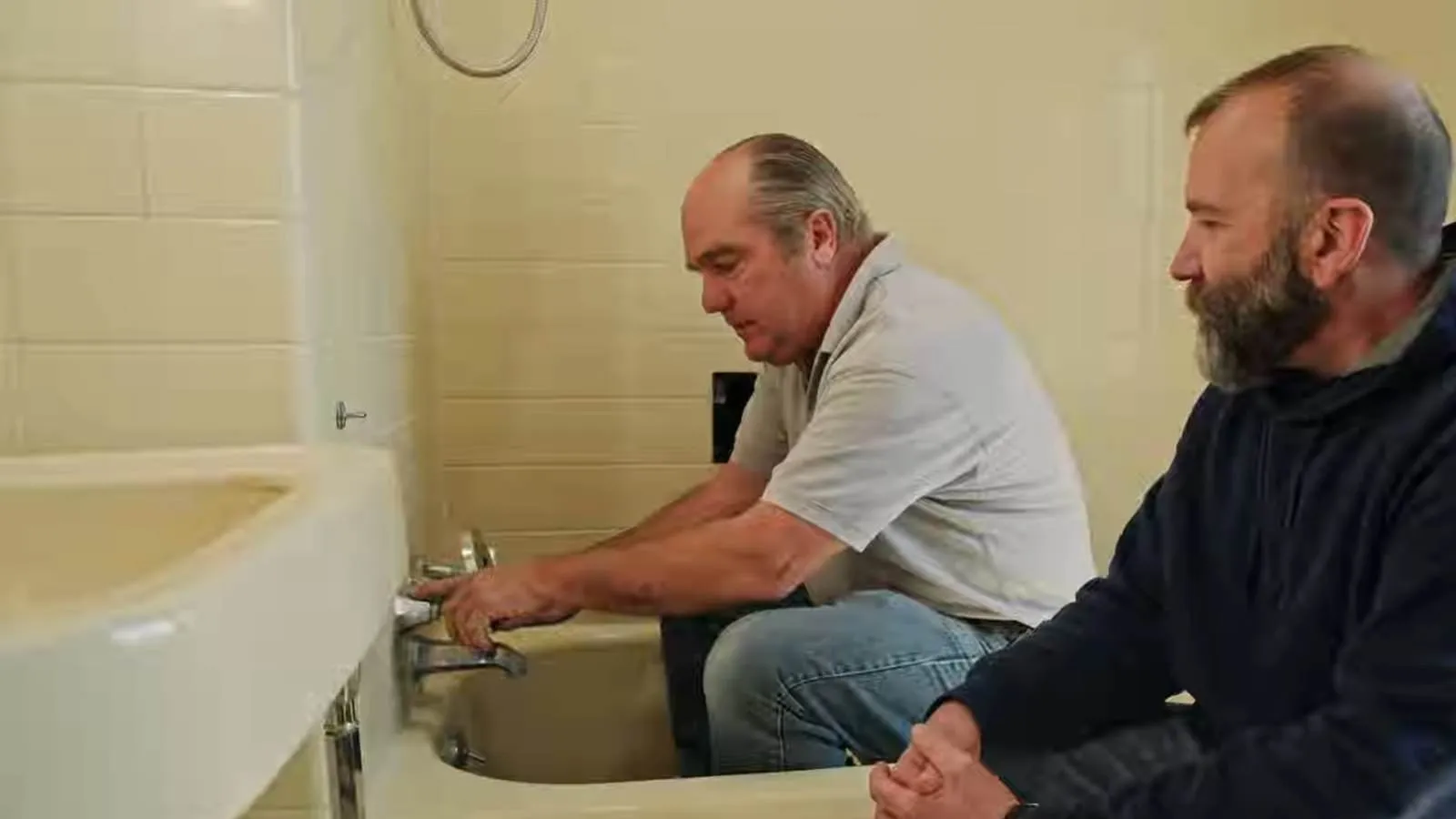 Plumber repairing a tub and shower valve in a Hempstead home